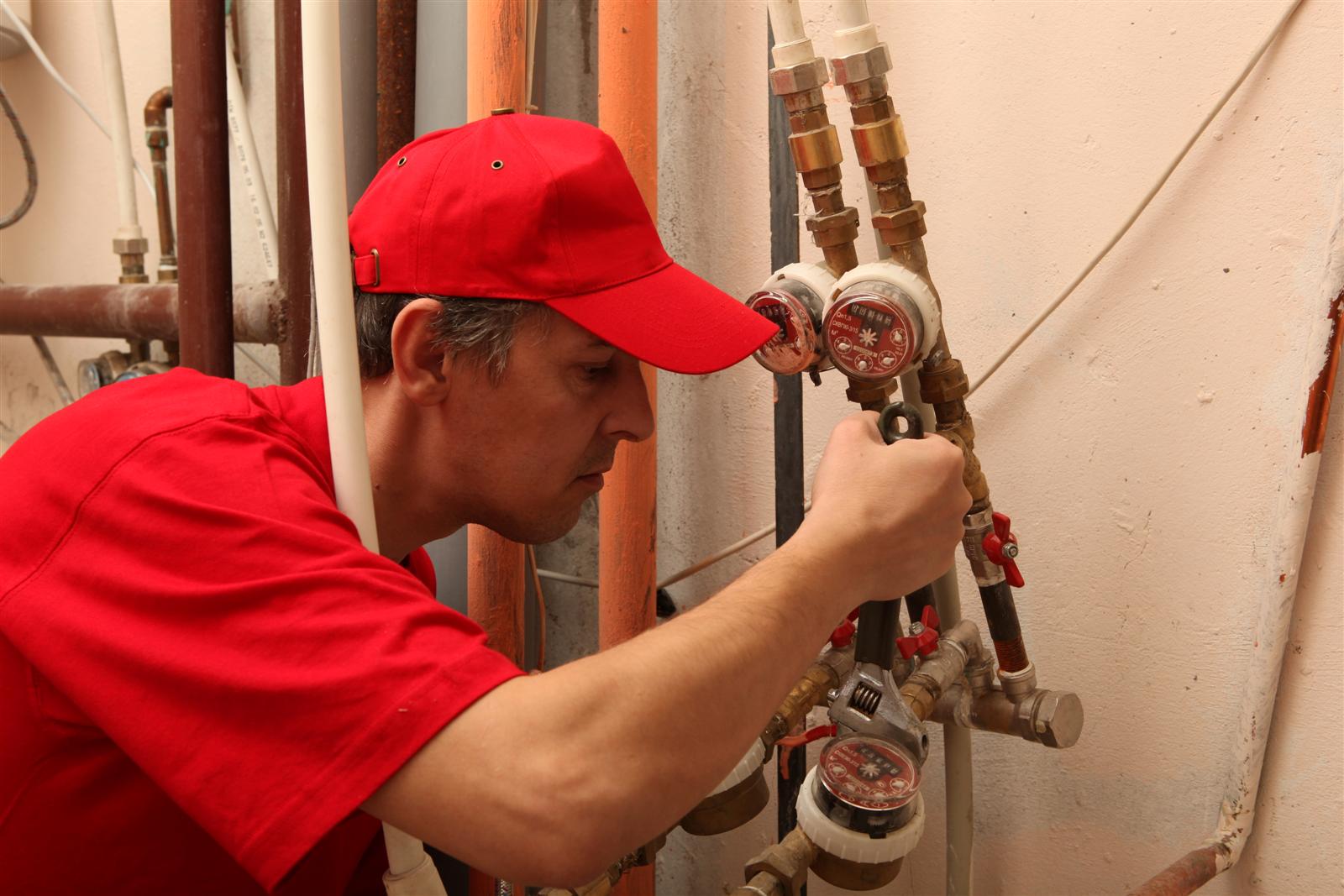 Plumber working in a home